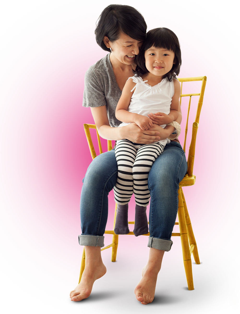 Photo of a young mother embracing her daughter. A pink sun flare illuminates behind them.