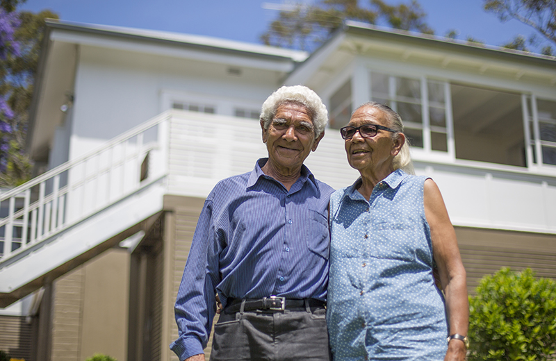 Couple standing outside of house